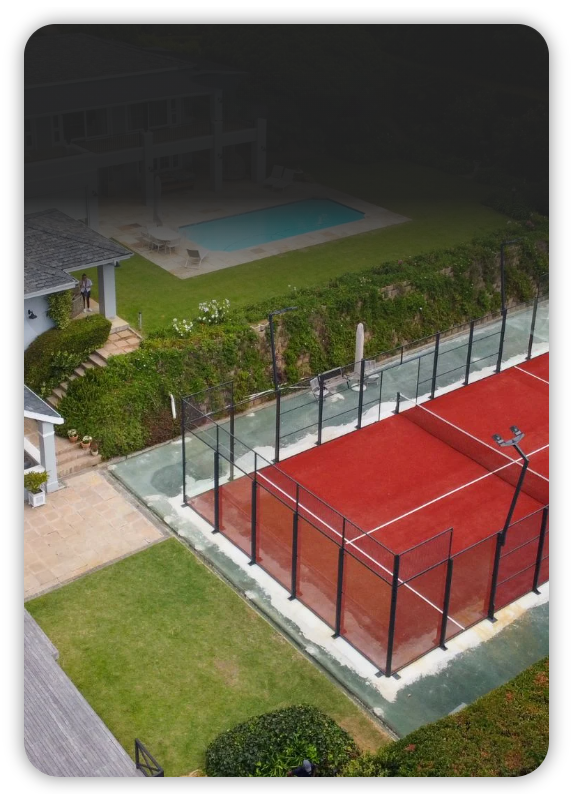 Red private padel court in a garden